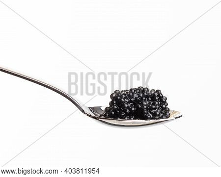 Fresh Grainy Black Paddlefish Caviar In Metal Spoon On White Background, Close Up