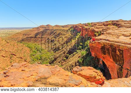 Carefree Woman Enjoying Panoramic Views Of Kings Canyon In Watarrka National Park, Australias Red Ce