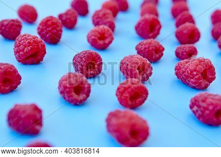 Raspberry Pattern, Blue Background, Top View\rpattern Of Ripe Red Raspberry On Blue Background. Vega