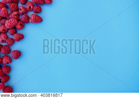 Raspberry Pattern, Blue Background, Top View\rpattern Of Ripe Red Raspberry On Blue Background. Vega