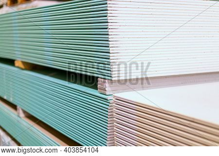 Pallet With Drywall Sheets Plasterboard In The Building Warehouse Store. Stacking Of White Gypsum Pa