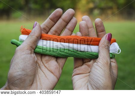 Indian Flag Tricolor Tiranga Saffron, White And Green Embroidery Threads. Female Palms Holding Embro