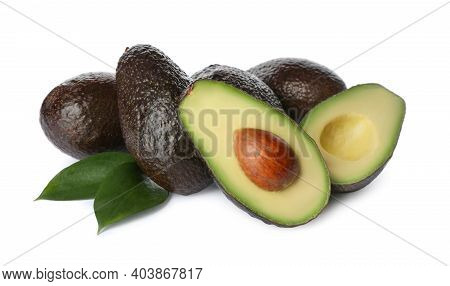 Cut And Whole Hass Avocadoes With Green Leaves On White Background