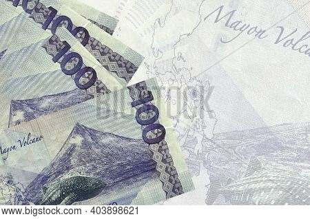 100 Philippine Piso Bills Lies In Stack On Background Of Big Semi-transparent Banknote. Abstract Bus