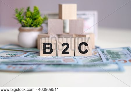 Dollars Banknote With Calculator And Word B2c. Banknotes And Wooden Cubes With Letters. Tax Concept 