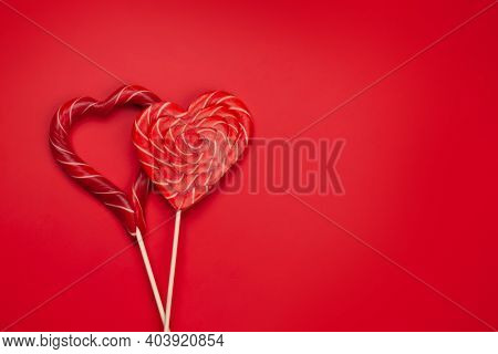 Valentines day greeting card template. Heart candy sweets over red background. Top view flat lay with copy space