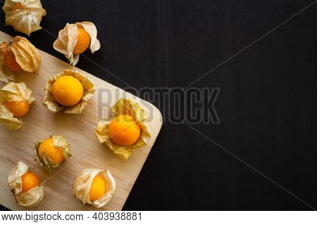 Cape Gooseberry Or Physalis Minima On Wood Background. Tropical Fruit And Food For Health Concept.
