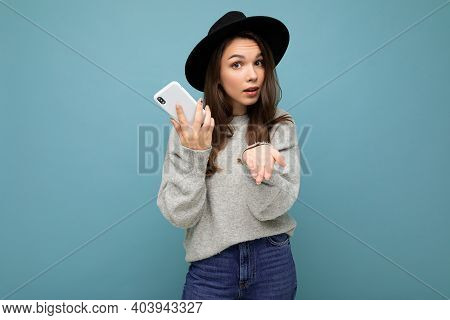 Beautiful Young Asking Dissatisfied Brunette Woman Pointong Hand At Camera Wearing Black Hat And Gre