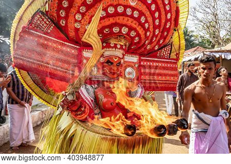 Payyanur, India - December 5, 2019: Theyyam artist perform during temple festival in Payyanur, Kerala, India. Theyyam is a popular ritual form of worship in Kerala, India