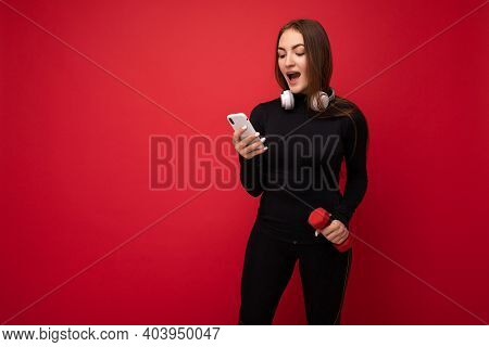 Photo Of Attractiveb Amazed Positive Young Brunette Woman Wearing Black Sport Clothes White Headphon