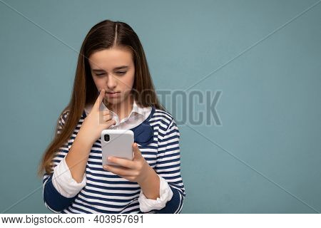 Beautiful Young Girl Wearing Casual Clothes Standing Isolated Over Background Surfing On The Interne
