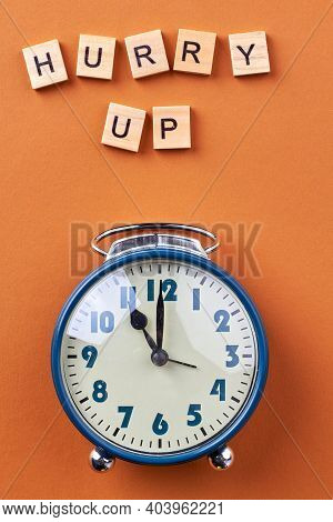 Hurry Up Concept Flat Lay. Vertical Shot Blue Alarm Clock.