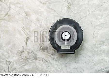 White Tissue Rolls In A Black Circle Plastic Box Hang On A Concrete Loft Wall. Tissue Paper In Boxes
