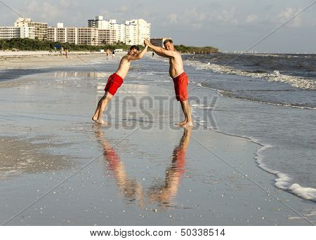 Father And Son Have Fun At The Beach