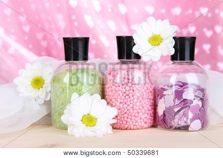 Aromatherapy minerals - colorful bath salt on pink background