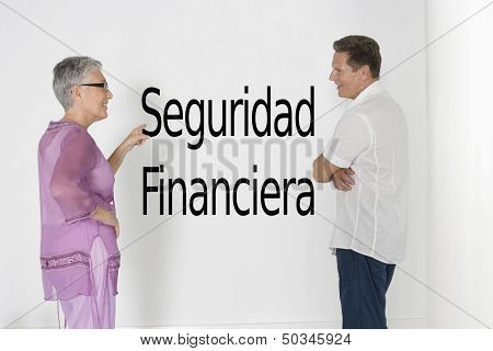 Couple discussing financial security against white wall with Spanish text 
