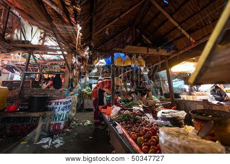 PADANG - AUGUST 25: Traders work at their stalls sell local farm produce at a village market in Padang, Sumatera, Indonesia on August 25, 2013. Agriculture and fishery is an important industry here.