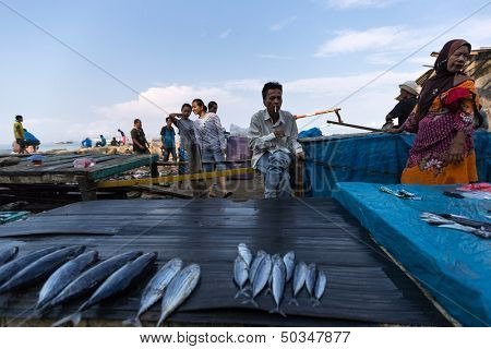 PADANG - AUGUST 25: Fishmongers wait for customers in a stall at an outdoor village market in Padang, West Sumatera, Indonesia on August 25, 2013. Resources from the sea is a major revenue earner.  