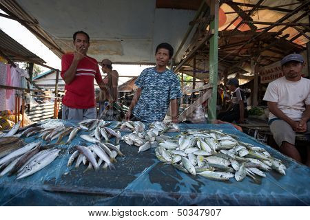 PADANG - AUGUST 25: Fishmongers wait for customers in a stall at an outdoor village market in Padang, West Sumatera, Indonesia on August 25, 2013. Resources from the sea is a major revenue earner.  