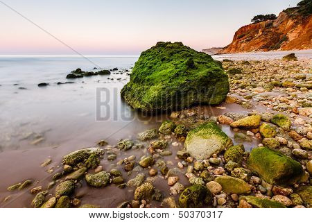 Green Stones At Porto De Mos Beach In Lagos, Algarve, Portugal