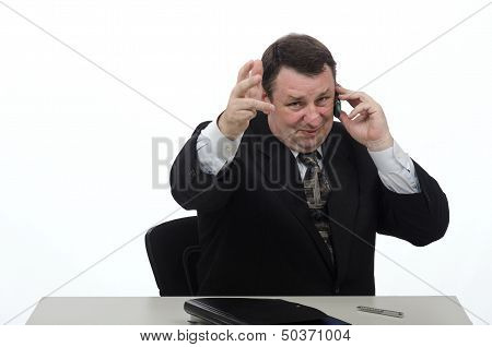 Gesturing Middle-aged Businessman Talking On The Phone In Office