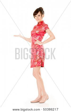 Smiling Chinese woman dress traditional cheongsam and introduce on white background.