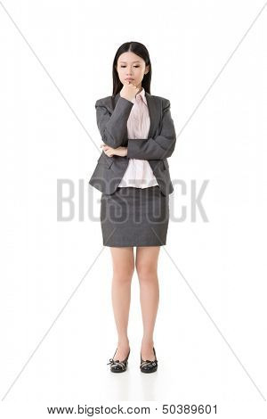 Worried, upset, thoughtful, pensive asian business woman. Full length portrait. Isolated on the white background.