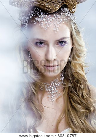 beauty young snow queen in fairy flashes with crown on her head