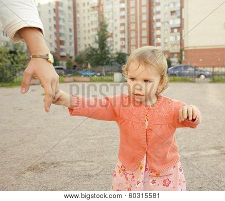 little girl with mother outside