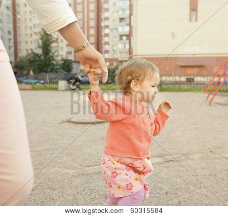 little girl with mother outside
