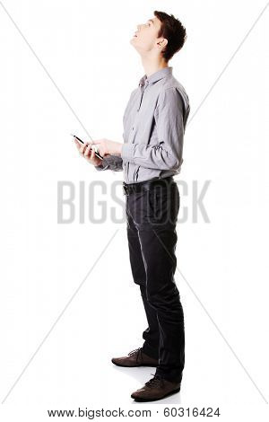 Young businessman using tablet computer isolated on white background