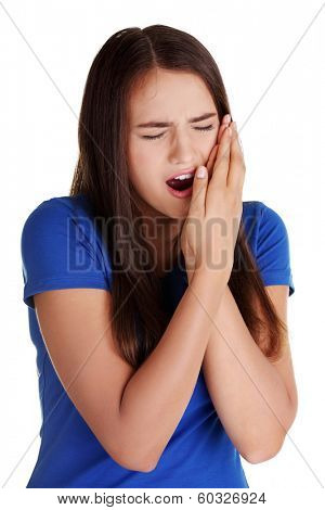 Teen woman pressing her bruised cheek with a painful expression as if she's having a terrible tooth ache. 