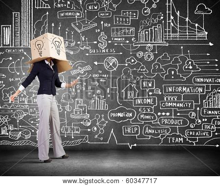 Businesswoman using mobile phone wearing carton box on head