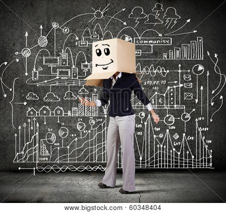 Businesswoman using mobile phone wearing carton box on head
