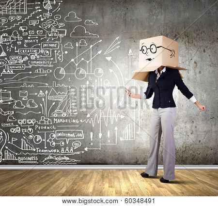 Businesswoman using mobile phone wearing carton box on head