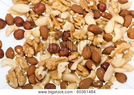 mixed nuts - hazelnuts walnuts cashews pine nuts isolated on white background