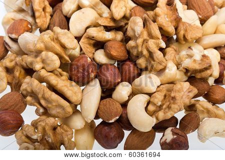 background of mixed nuts - hazelnuts walnuts cashews pine nuts