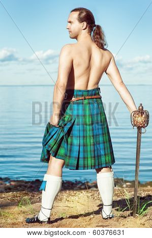 Scottish Man With Sword Near The Sea