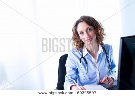 portrait of a beautiful female doctor writing