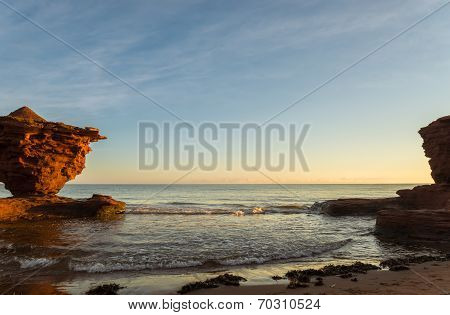 Red Sandstone Rocks At High Tide