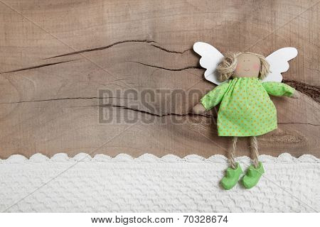 Top View Of Angel With Crochet Strip On Wooden Background For Christmas