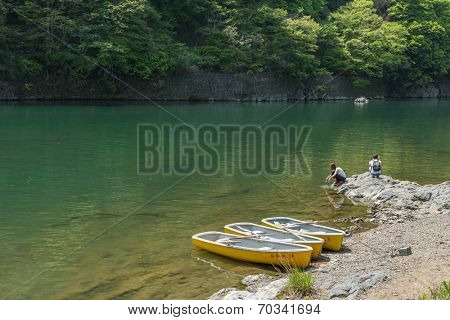 KYOTO, JAPAN - APRIL 26th  : Three canoes docked at the shore of Hozu(Katsuragawa)  River in Arashiyama in Kyoto, Japan on 26th April 2014.