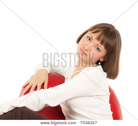 Pretty blond Girl in red Ledersessel