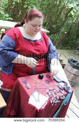 MUSKOGEE, OK - MAY 24: Women show art of lace making, as it was made in the Middle Ages, at the Oklahoma 19th annual Renaissance Festival on May 24, 2014 at the Castle of Muskogee in Muskogee, OK 