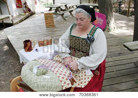 MUSKOGEE, OK - MAY 24: Women show art of lace making, as it was made in the Middle Ages, at the Oklahoma 19th annual Renaissance Festival on May 24, 2014 at the Castle of Muskogee in Muskogee, OK 