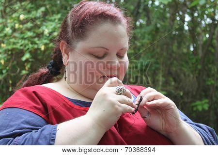MUSKOGEE, OK - MAY 24: Women show art of lace making, as it was made in the Middle Ages, at the Oklahoma 19th annual Renaissance Festival on May 24, 2014 at the Castle of Muskogee in Muskogee, OK 