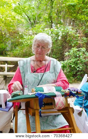 MUSKOGEE, OK - MAY 24: Women show art of lace making, as it was made in the Middle Ages, at the Oklahoma 19th annual Renaissance Festival on May 24, 2014 at the Castle of Muskogee in Muskogee, OK 