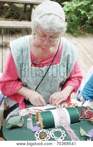 MUSKOGEE, OK - MAY 24: Women show art of lace making, as it was made in the Middle Ages, at the Oklahoma 19th annual Renaissance Festival on May 24, 2014 at the Castle of Muskogee in Muskogee, OK 