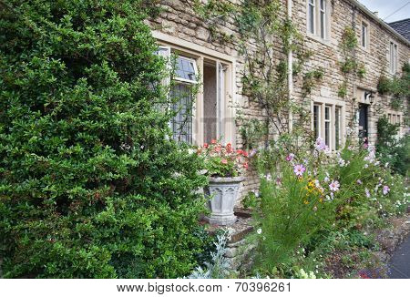 WILTSHIRE, CHIPPENHAM, UK - AUGUST 9, 2014: Castle Combe, unique old English village with luxury hot