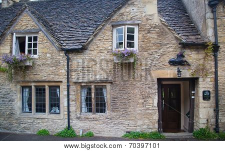 WILTSHIRE, CHIPPENHAM, UK - AUGUST 9, 2014: Castle Combe, unique old English village with luxury hot